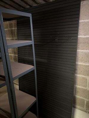 a shelf in the corner of a room with a brick wall