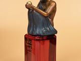 a statue of a man sitting on top of a red box