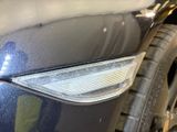 a close up of a car ' s headlight and front bumper