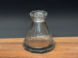 a small glass vase sitting on top of a wooden table