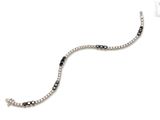 a close up of a bracelet with black and white stones on it