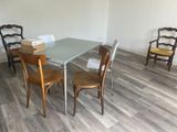 a table and chairs in a room with wood flooring