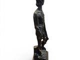 bronze statue of a man with a hat and a cane
