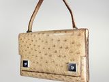 an ostrich leather handbag with a metal clasp