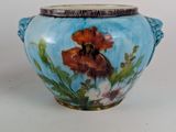 a blue vase with a flower painted on it