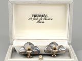 pair of silver and gold cufflinks in a box