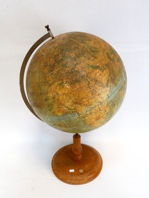 un vieux globe terrestre posé sur un socle en bois, sur fond blanc