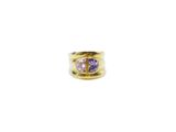 a gold ring with a purple stone in the center