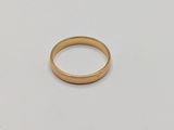 a close up of a gold ring on a white surface