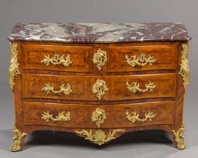 an antique chest of drawers with a marble top