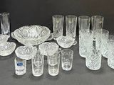 a lot of glasses and vases on the table