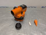 a close up of an orange surveying device on a table