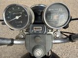 two gauges on the handlebars of a motorcycle