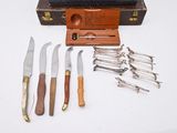 five different types of knives and a case on the table