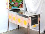 a pinball machine in a room with a white curtain