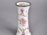 a white vase with a floral design on it