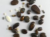 some brown and white rocks and pebbles on a white surface