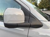 a close up of a side view mirror on a white car
