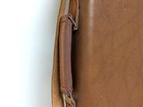 a brown leather case with a handle on it