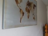 a picture of a bedroom with a bed and a painting on the wall