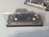 two model cars in a display case on a table
