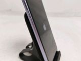 a close up of a cell phone on a stand on a table