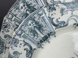 a blue and white plate with a design on it