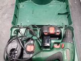 a green box with tools in it sitting on the floor