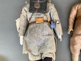 two dolls that are sitting next to each other on a table