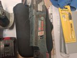 a picture of a cluttered workbench with tools on it