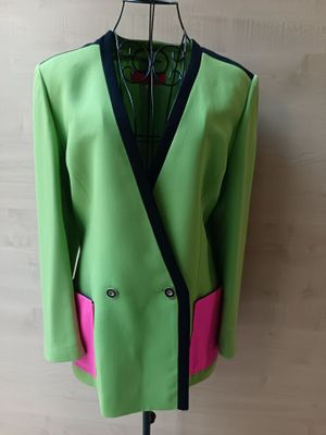 a green jacket with pink trim on a mannequin mannequin mannequin mannequin mannequin mannequin mannequin mannequin