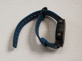 the watch is blue and has a black band on it
