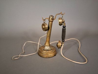 un téléphone doré relié à un fil