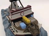 a toy boat that is on a rock in the water