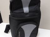 a black and grey backpack sitting on a white table