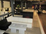 an image of a large room with couches and tables