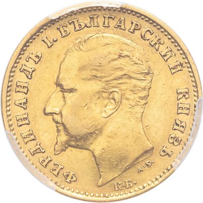 a close up of a gold coin with a profile of a man