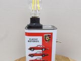 a light that is sitting on a table next to a can of motor oil