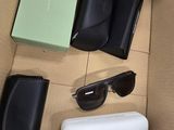 a box with sunglasses, sunglasses case, and other items in it