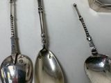 three spoons that are sitting next to each other on a table