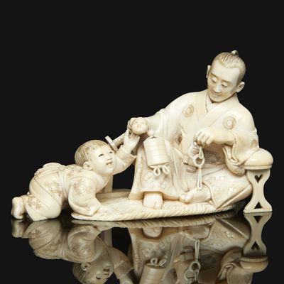 chinese carved ivory figurine of a man and child on a bench