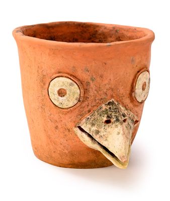 a clay pot with a bird head on it