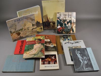Plusieurs livres sont disposés sur une table devant un fond gris.