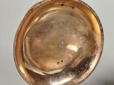a silver plate on a stand on a table