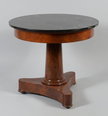 a round table with a black marble top on a wooden stand