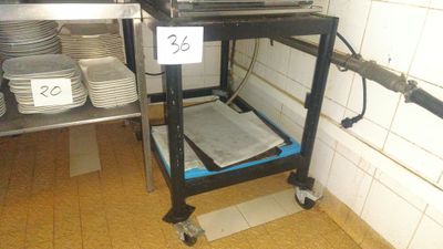 a small cart with plates on it in a kitchen