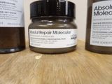 three bottles of absolut repair moussure sitting on a table