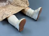 a close up of a doll ' s legs with a dress and shoes