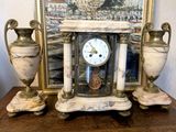 a picture of a clock and two vases on a table