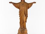wooden statue of jesus with open arms on a white background